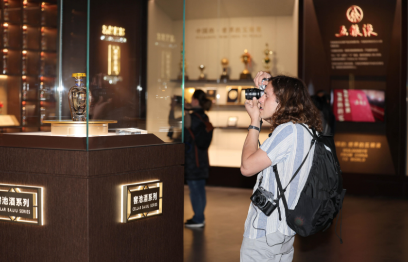 Jihoafrická účastnice akce pořizuje snímky z likérky..  Foto: Guangming Online)